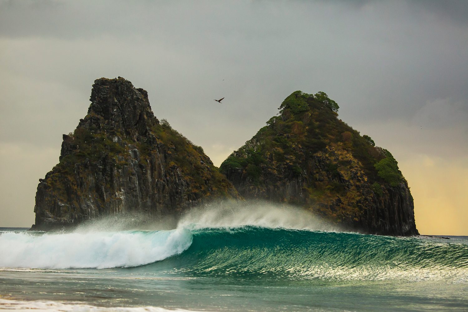 Two steep sea stacks rising above the surf